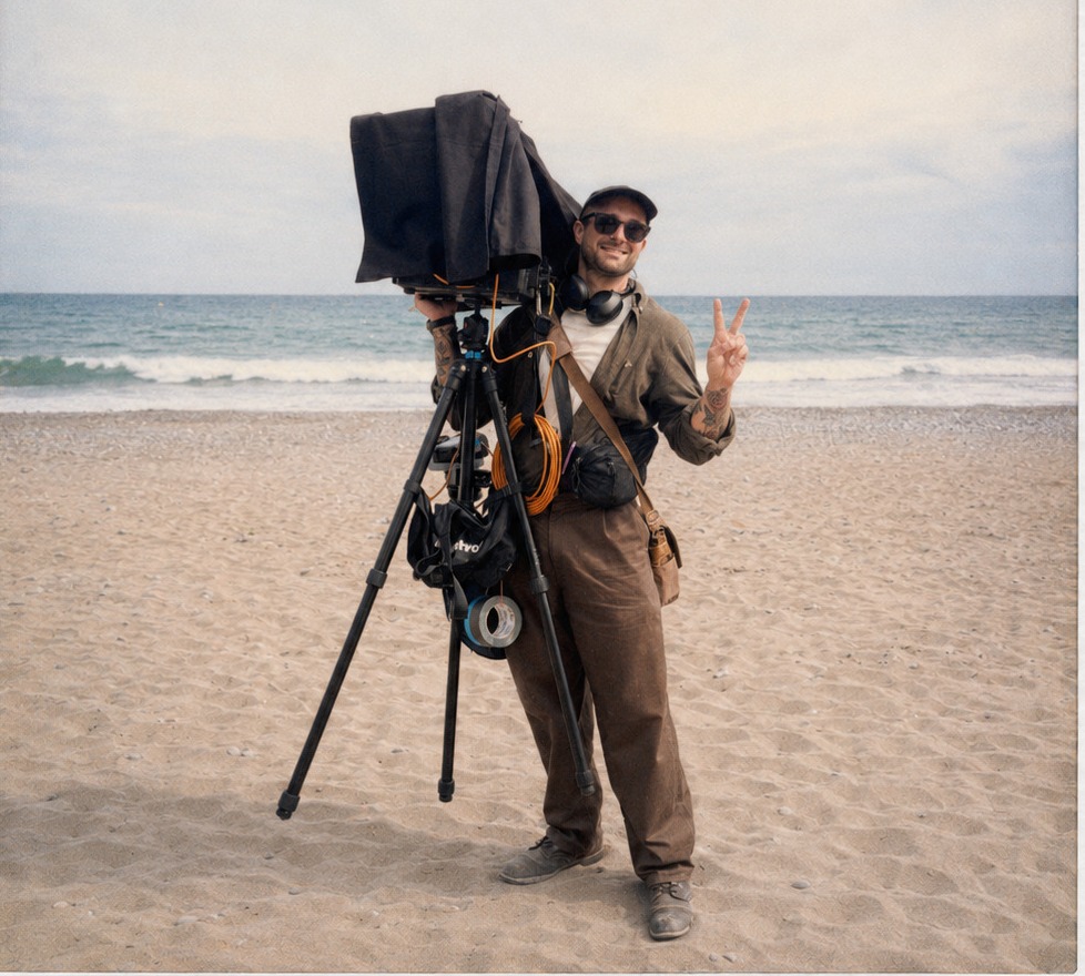 James Huertas on a beach with his digital technician station.
